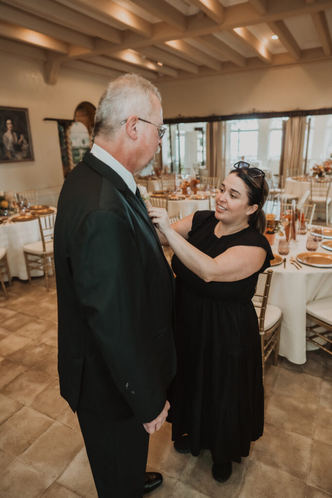 planner putting on boutonniere